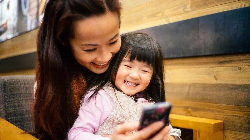woman on mobile with daughter